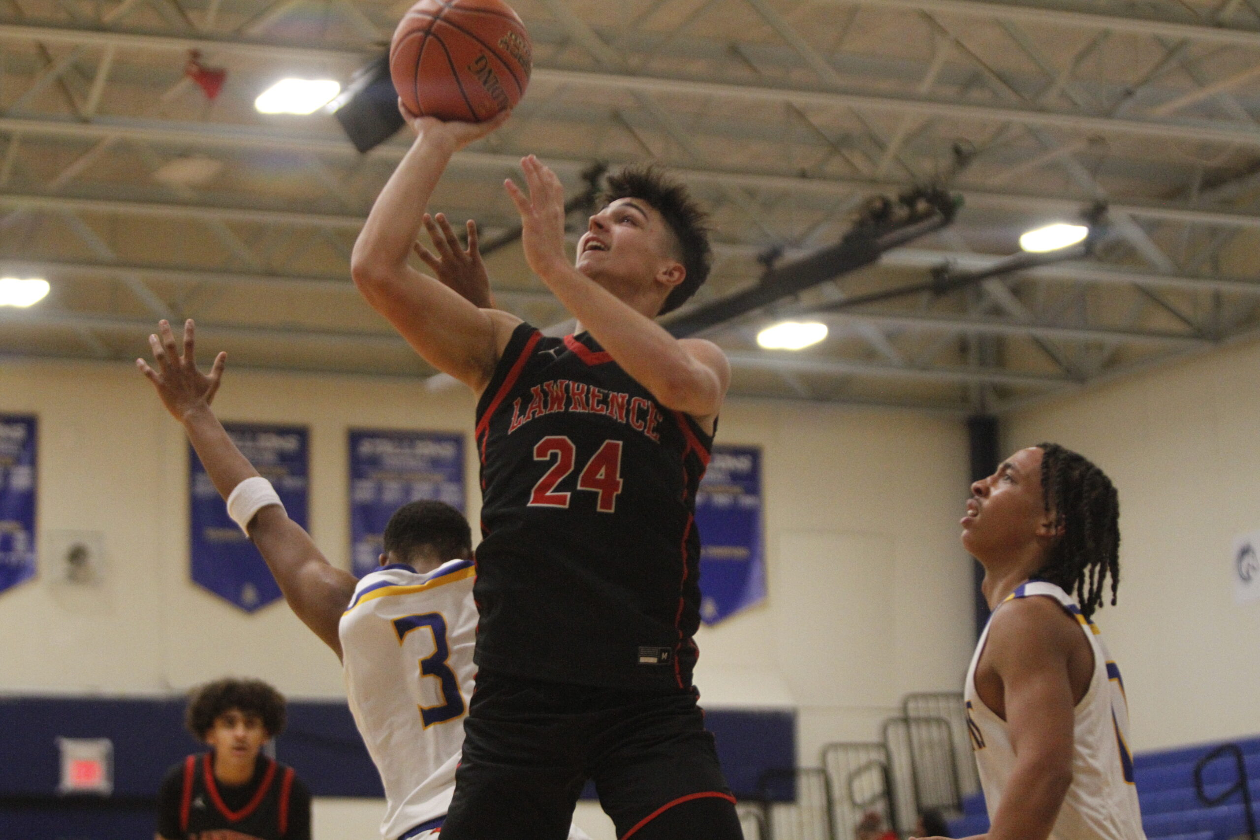 Lawrence boys basketball overcomes slow start in double-digit road win ...